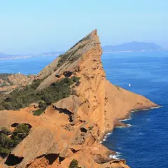 Le Bec de l'Aigle à La Ciotat, un promontoire rocheux aux teintes ocres plongeant dans la mer d'un bleu profond.