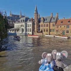 Deux peluches souris profitent d'une balade en bateau sur les canaux de Bruges, une excellente idée pour savoir que faire à Bruges.
